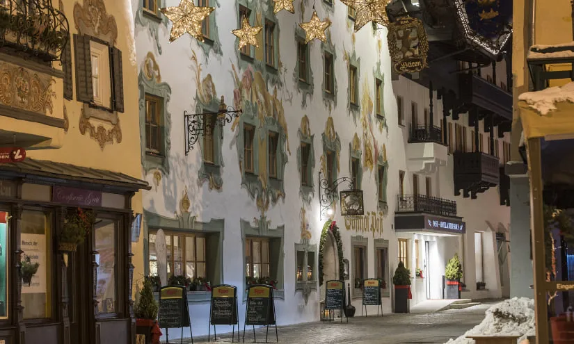 Charming winter street with decorated buildings and lights