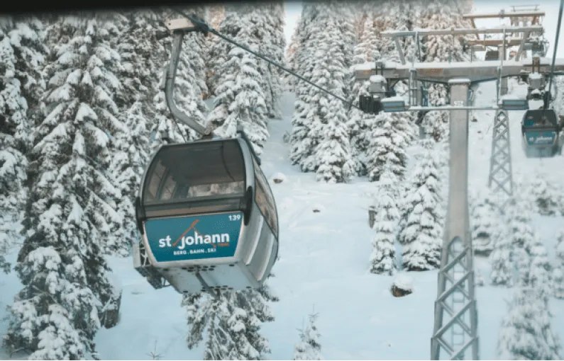 Cable car in snowy forest near St. Johann
